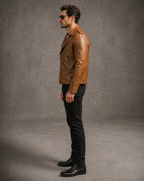 Man wearing a brown leather jacket and black pants against a gray background
